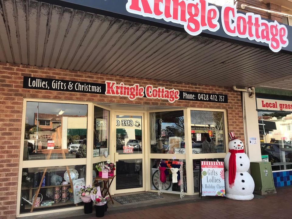 The Kringle Cottage shopfront on Oberon St with its sign reading Lollies, Gifts and Christmas, and a snowman by the door